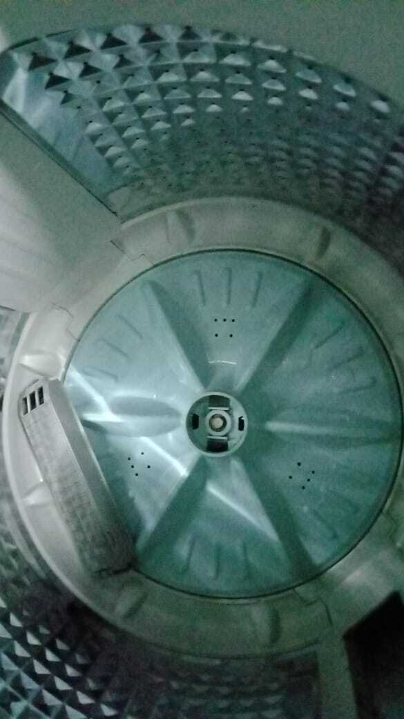 Drive belt and pulley being refitted on a washing machine